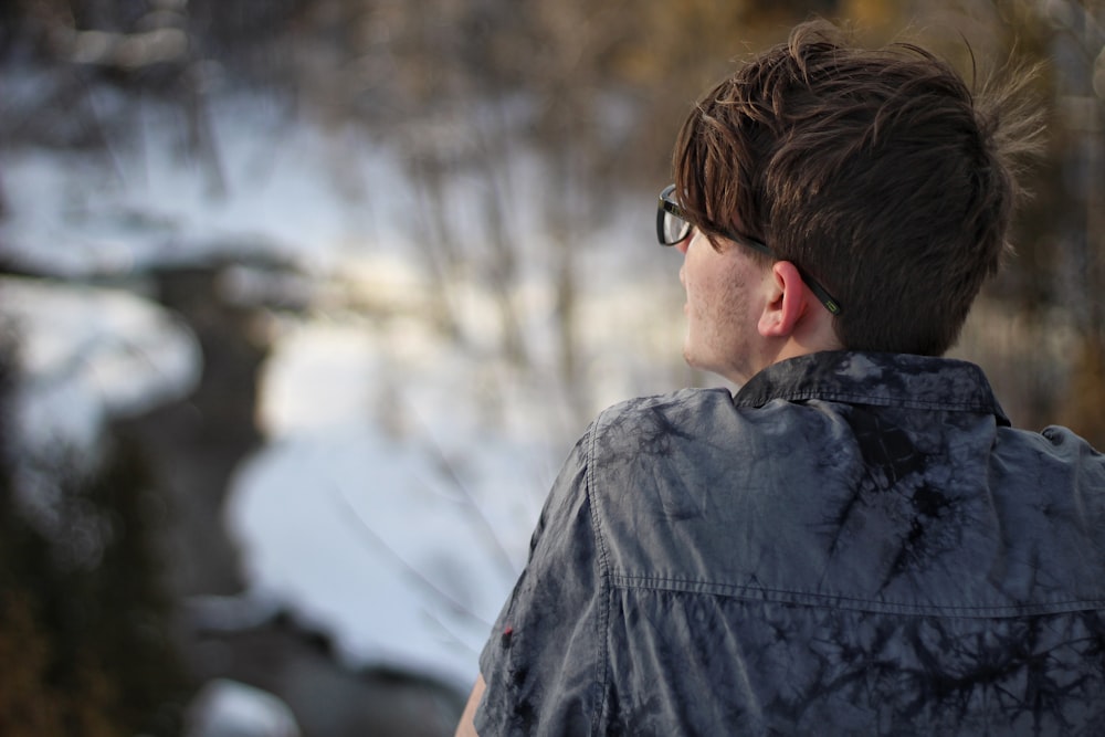 depth of field photography of man wearing gray collared shirt and eyeglasses