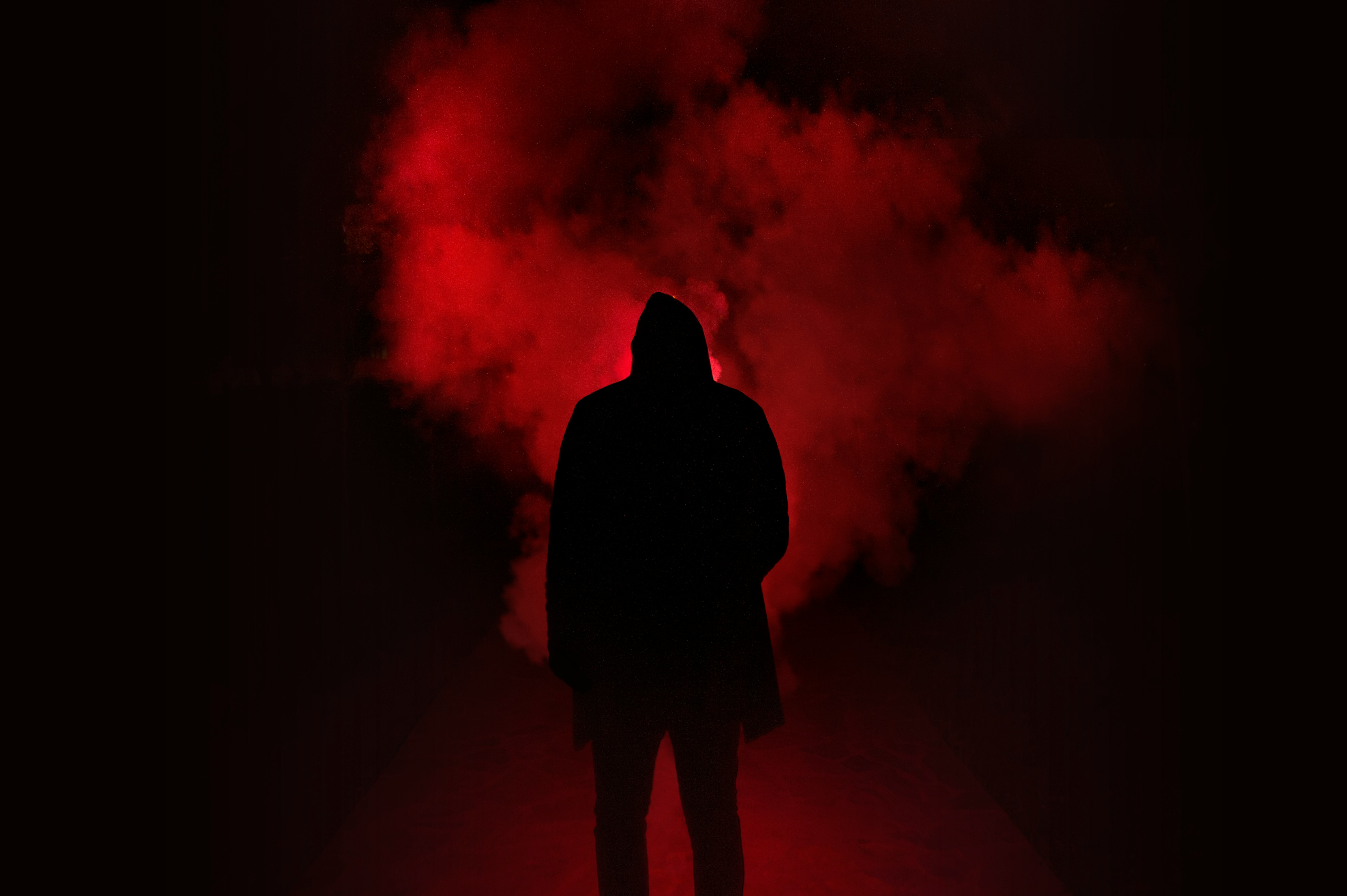 silhouette of person on a dark place with smoke