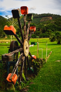 A vibrant water wheel spinning in a fish pond under sunlight.