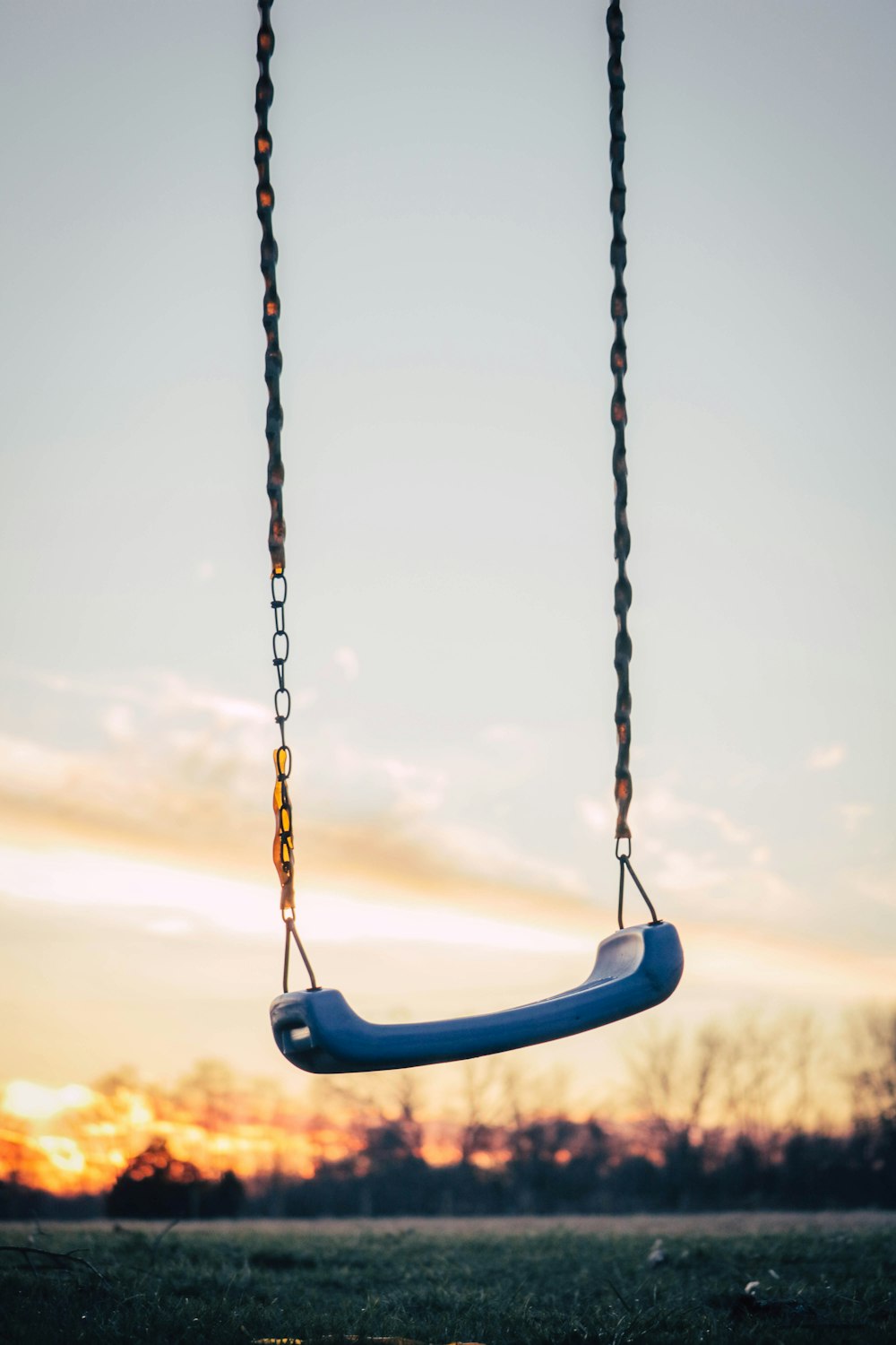 selective photography of blue plastic swing