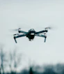 selective focus photography of flying quadcopter