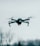 selective focus photography of flying quadcopter