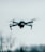 selective focus photography of flying quadcopter