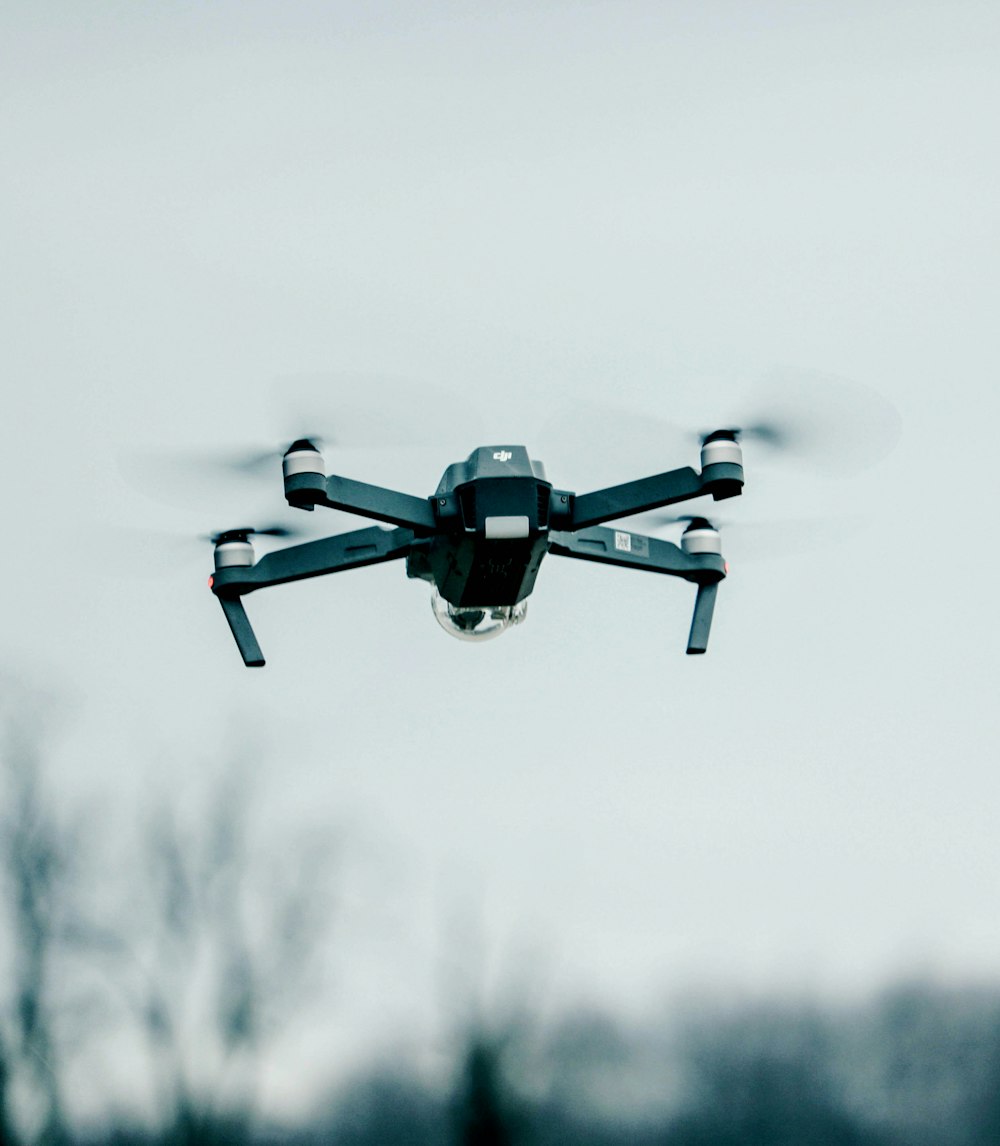 selective focus photography of flying quadcopter