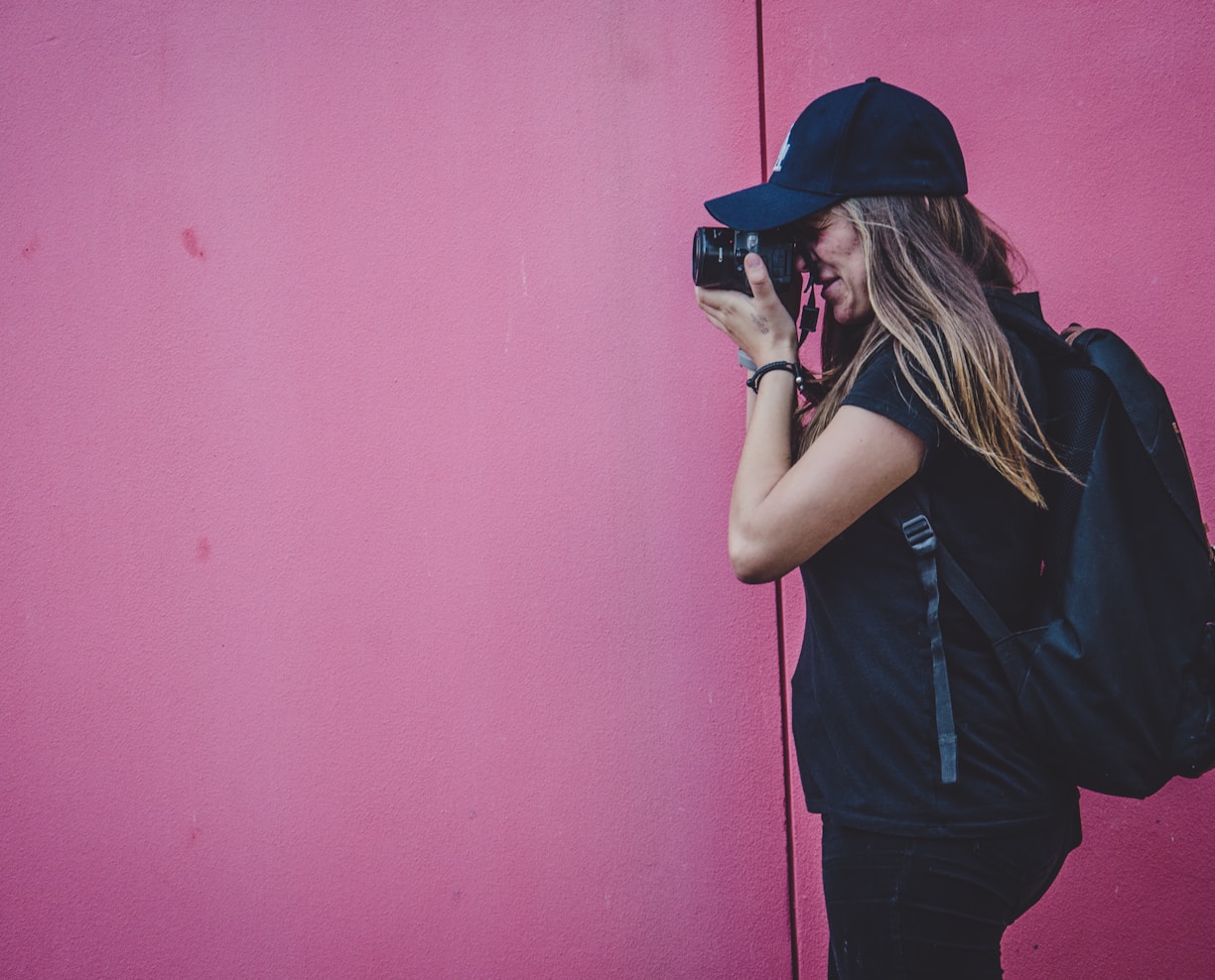 woman holding camera taking photo