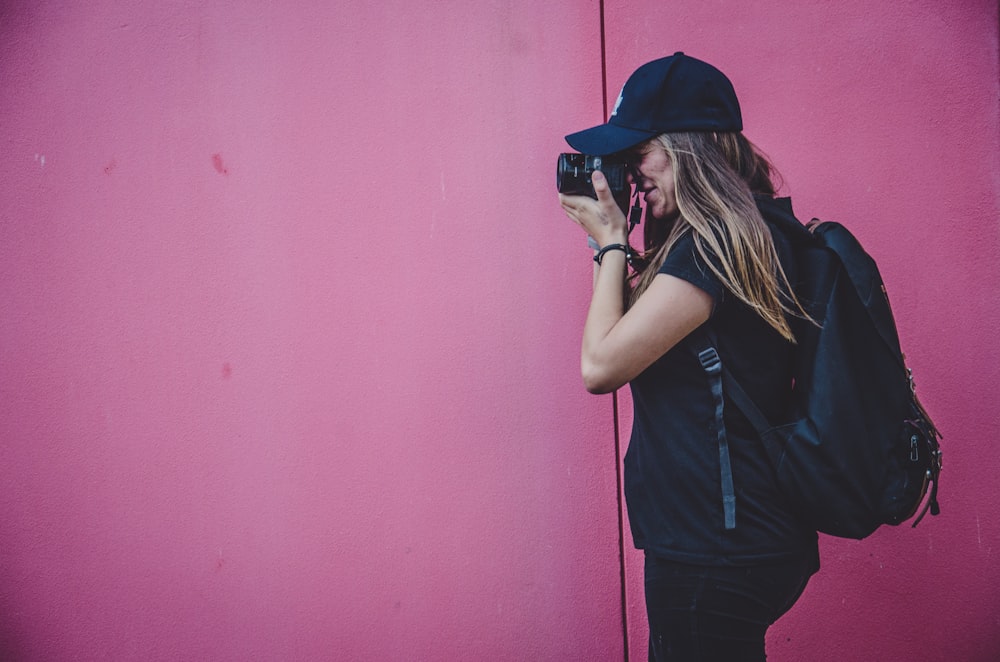 woman holding camera taking photo