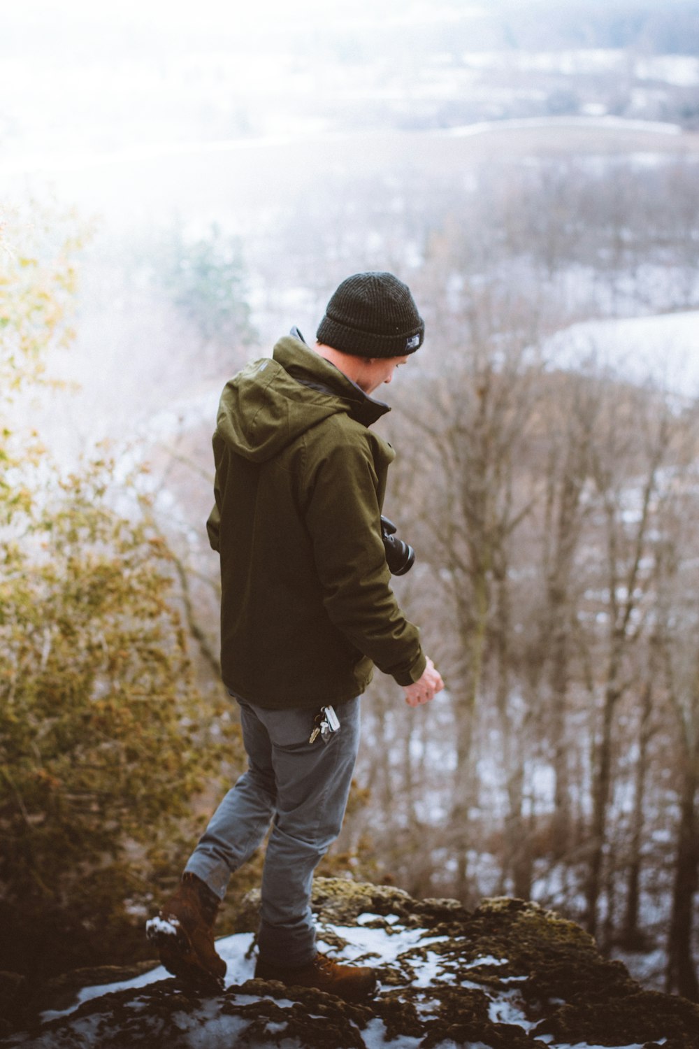 man standing on gray rock formation