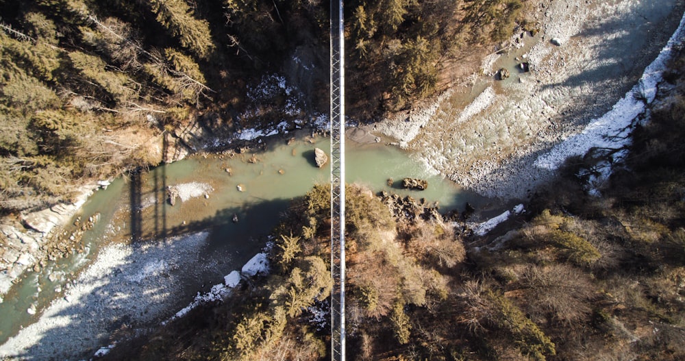 aerial photography of bridge over cliff with body of water at daytime