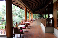 An elegant outdoor dining area with patterned tile flooring and tasteful plant accents.