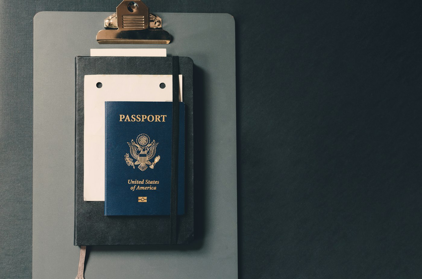 Passport and documents on a clipboard for UAE residency application