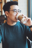 man holding Starbucks disposable cup
