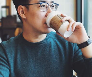 man holding Starbucks disposable cup