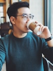 man holding Starbucks disposable cup