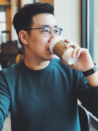 man holding Starbucks disposable cup