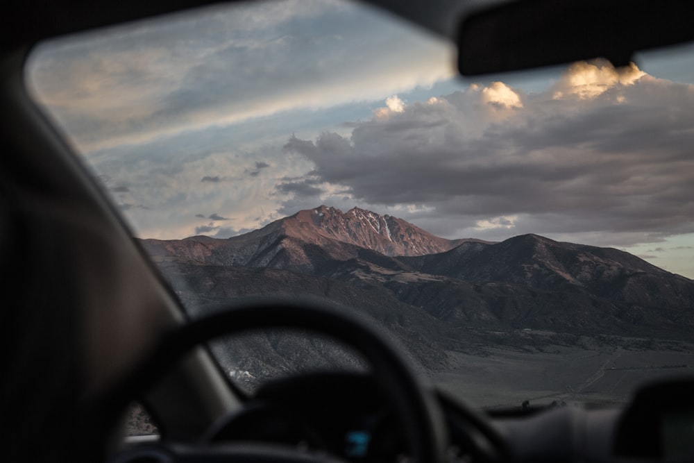 brown mountain with cloudy sky