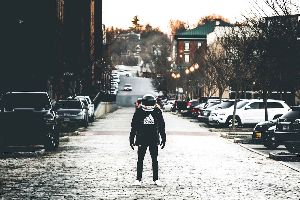 person wearing jacket and helmet on road