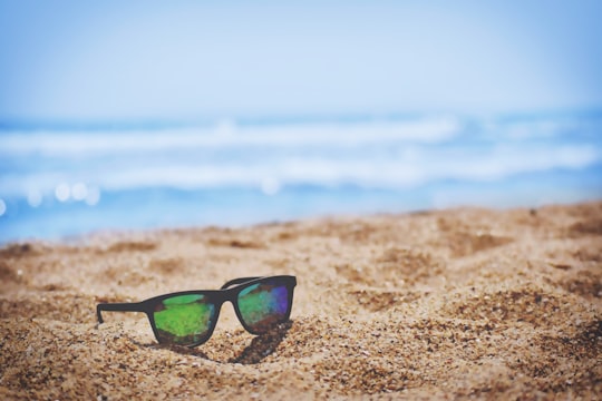 wayfarer sunglasses on beach sand during daytime in Rushikonda India