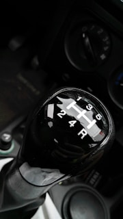 Various car transmissions displayed on a metal rack.