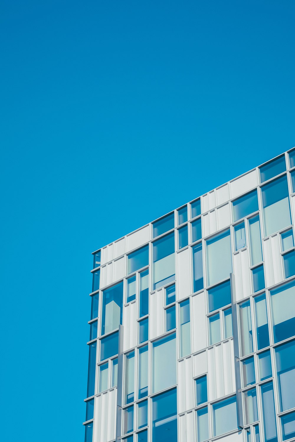 low angle photography of white and teal painted building