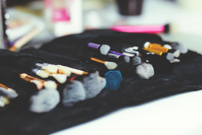 Creative makeup brush set gently resting on a soft white cloth background.