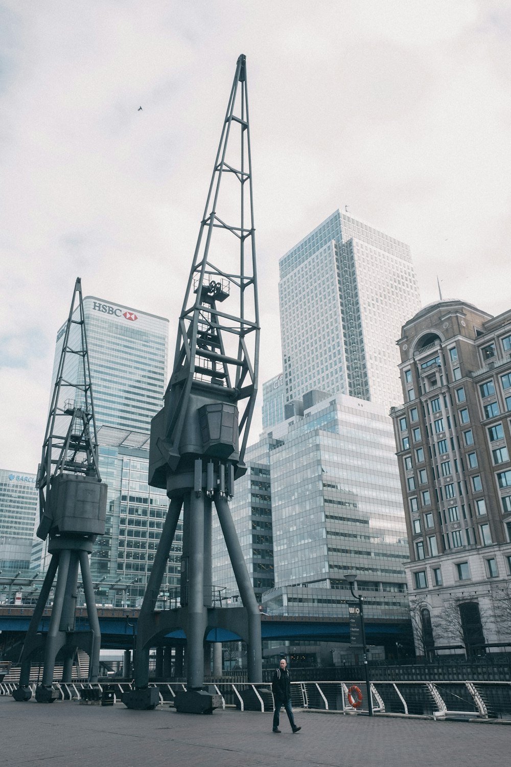 man walking near machines near buildings