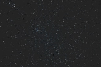 A glowing zodiac wheel with stars twinkling against a dark cosmic background.