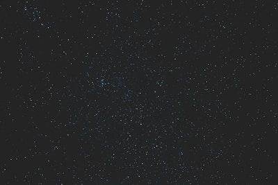 A glowing zodiac wheel with stars twinkling against a dark cosmic background.