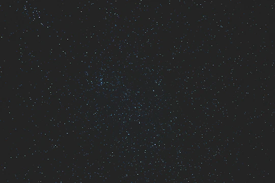 A vibrant screenshot of the Star Map app showing constellations glowing against a dark sky background.