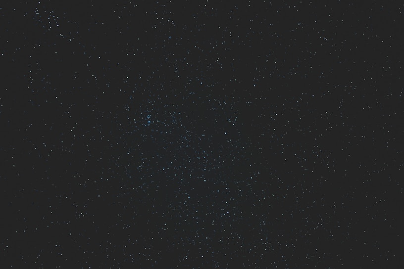 A close-up of a dark blue star map with silver constellations glowing softly.