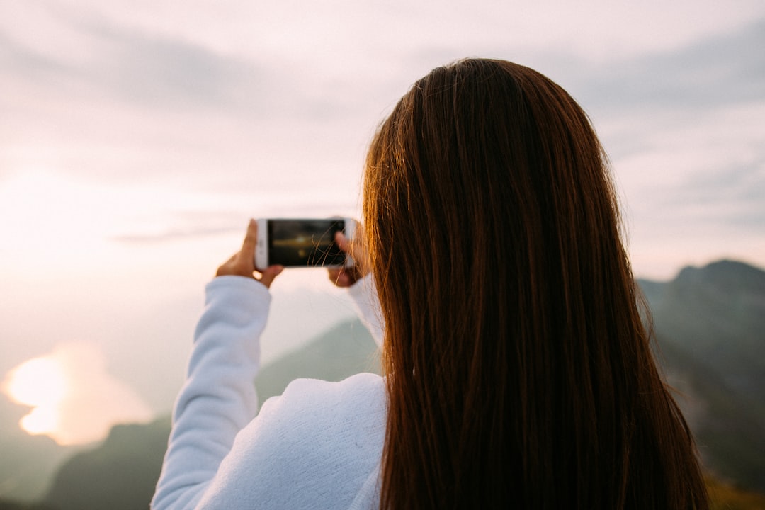 person holding smartphone taking photo