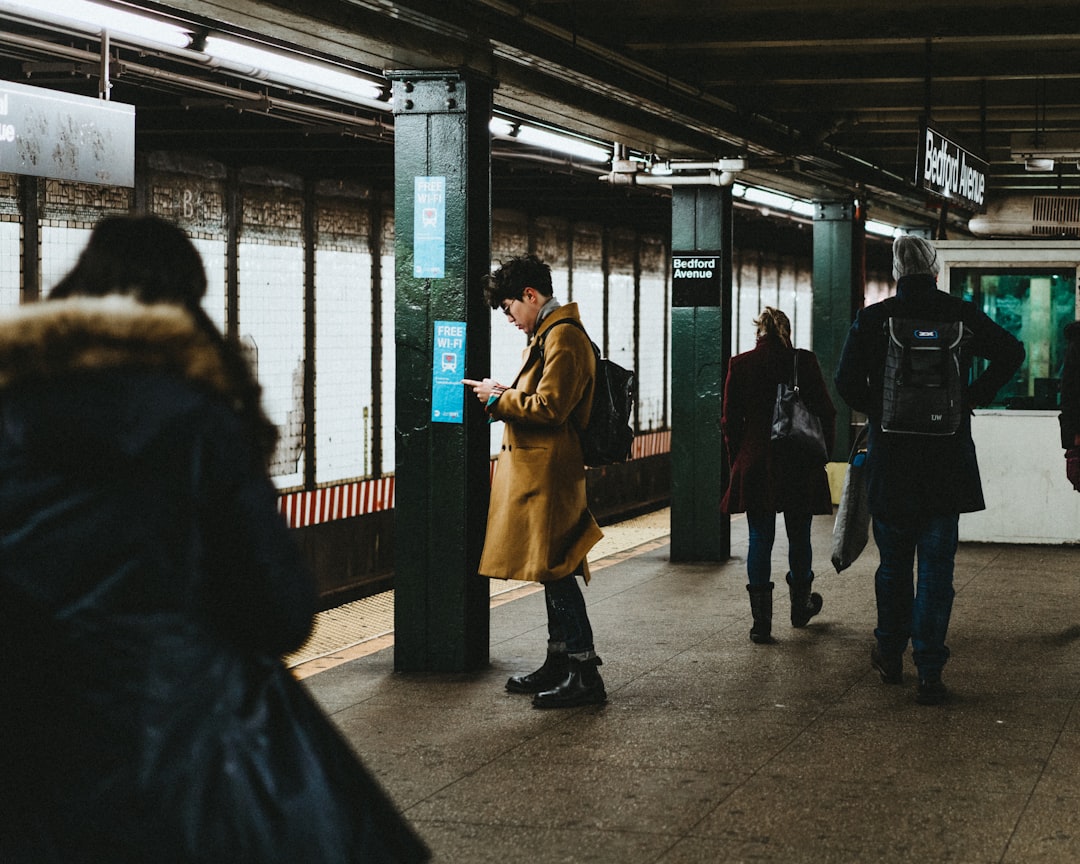 man using smartphone inside the train station, Time is an illusion