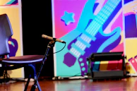 A dynamic moment from a live session streamed on YouTube, with Myrna speaking passionately against a blue-violet background.