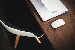 white Apple Magic mouse on brown table