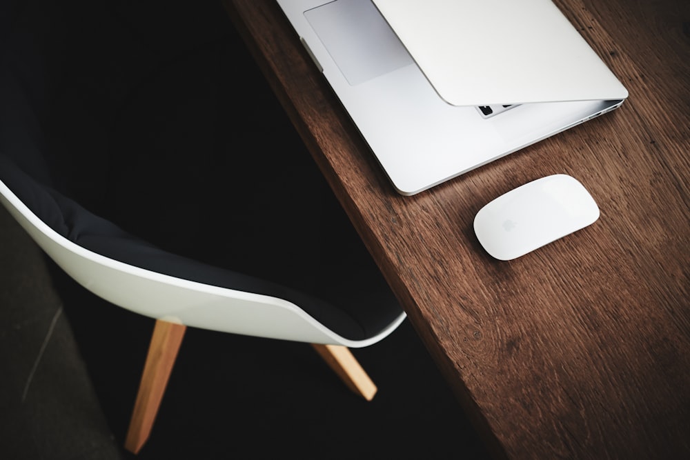 white Apple Magic mouse on brown table