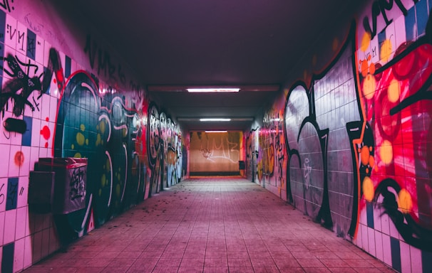 empty tunnel pathway with graffiti walls