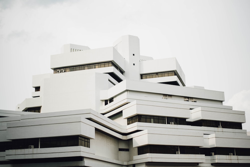 white painted concrete building taken under white clouds