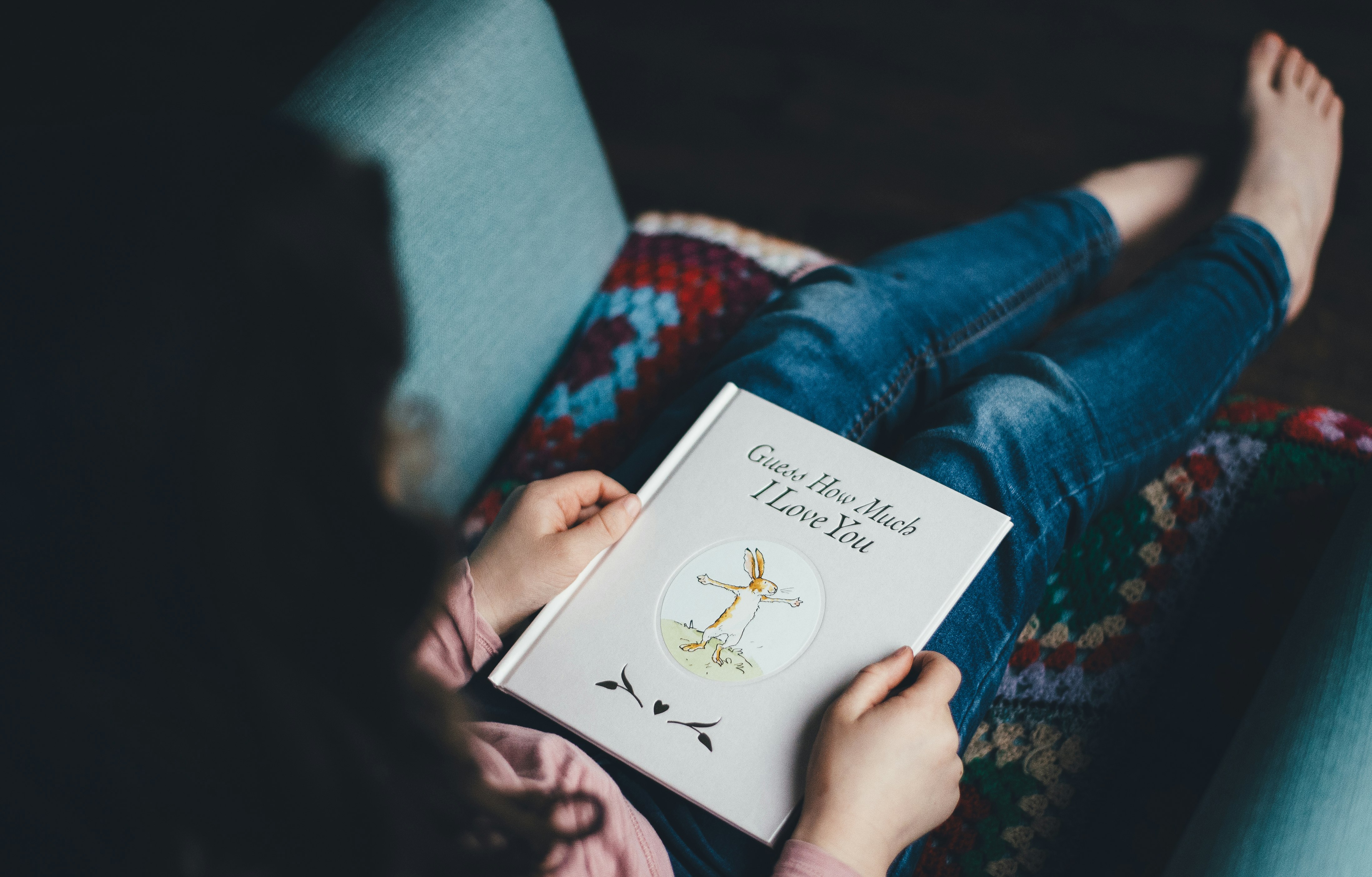 person sitting on chair reading book