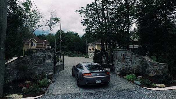 A sleek electric sliding gate opening smoothly at a residential driveway.