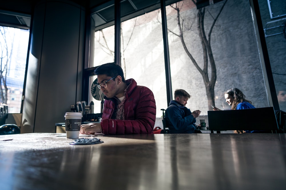 man sitting on brown table