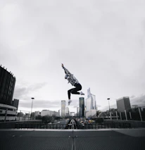 Close-up of a character performing a mid-air flip with cityscape background.