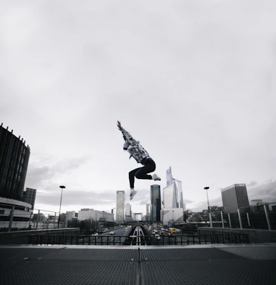 Close-up of a character performing a mid-air flip with cityscape background.