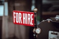 shallow focus photography of red and white for hire signage