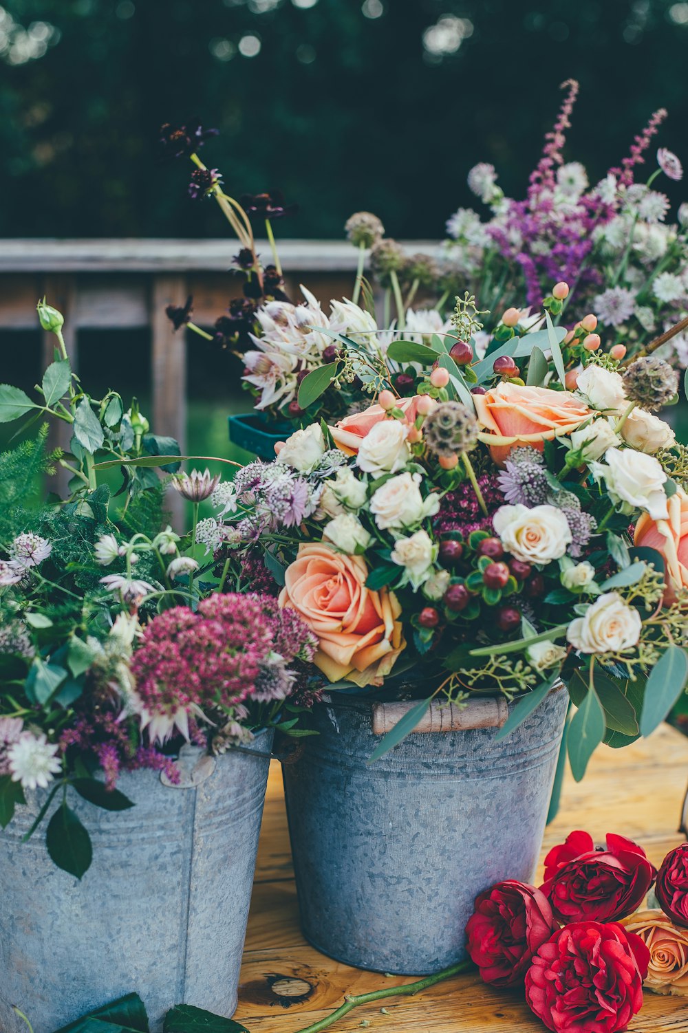 assorted flowers on gray metal bucket