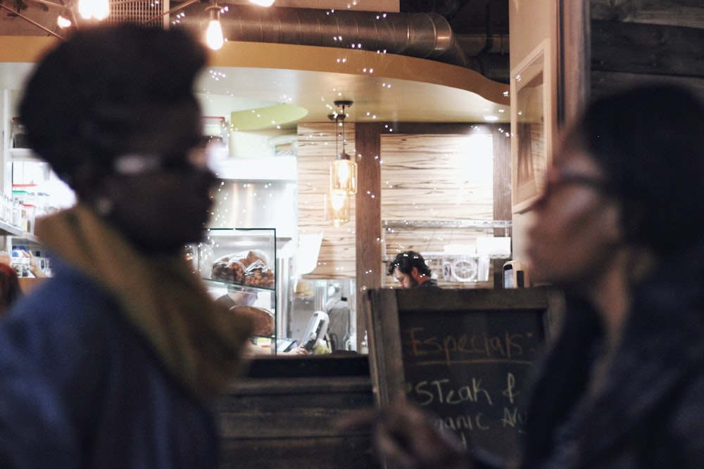 two women wearing eyeglasses in room