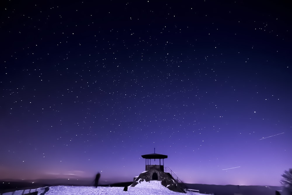 black concrete gazebo covered in snow