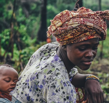 woman carrying baby on back