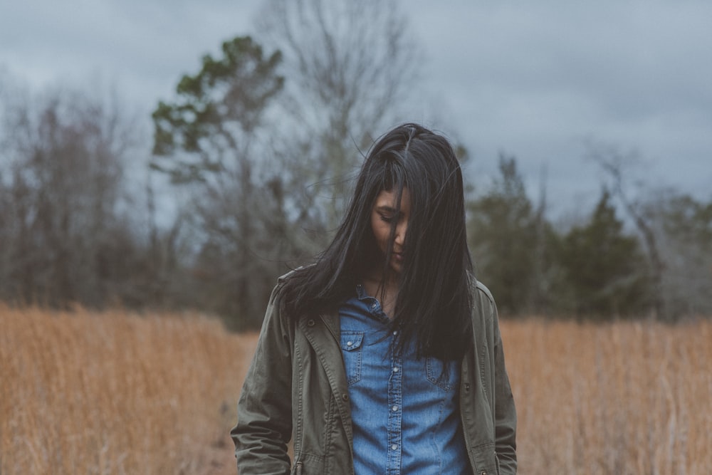 woman wearing gray cardigan surrounded grass