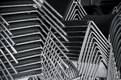 Close-up of premium office chairs stacked neatly on pallets, prepared for delivery.
