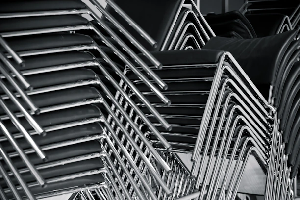 Close-up of neatly stacked used office chairs ready for collection in a modern office space.