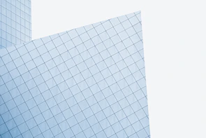Tempered glass panels installed on a modern office building with sharp architectural lines.
